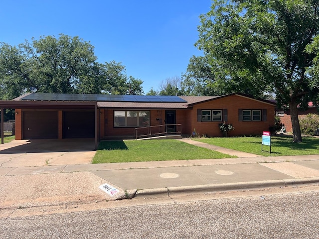 ranch-style house with a garage and a front lawn