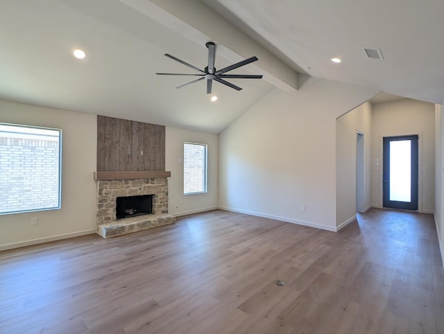 unfurnished living room with light hardwood / wood-style flooring, vaulted ceiling with beams, a fireplace, and ceiling fan