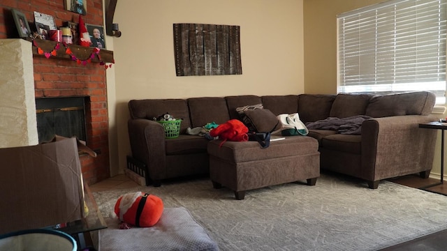 living room featuring a brick fireplace