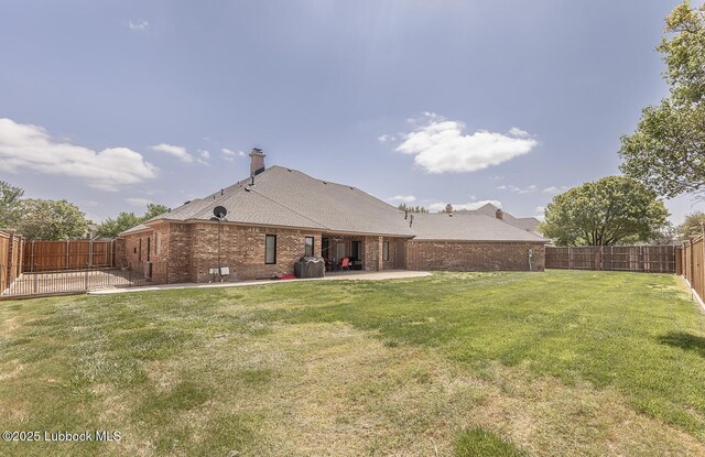 5004 County Rd 1430, Lubbock, TX 79407 - rear view of property with a patio area, brick siding, and a chimney