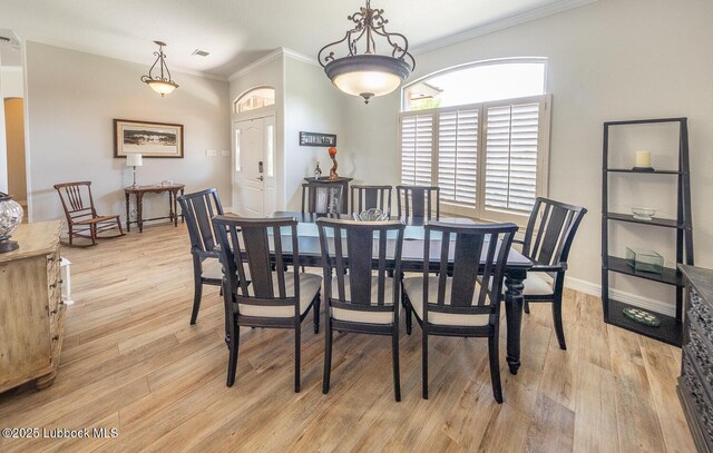 5004 County Rd 1430, Lubbock, TX 79407 - dining area with light wood finished floors, crown molding, and baseboards