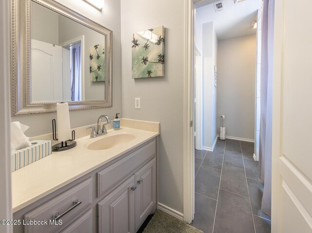 5004 County Rd 1430, Lubbock, TX 79407 - full bath featuring vanity and baseboards