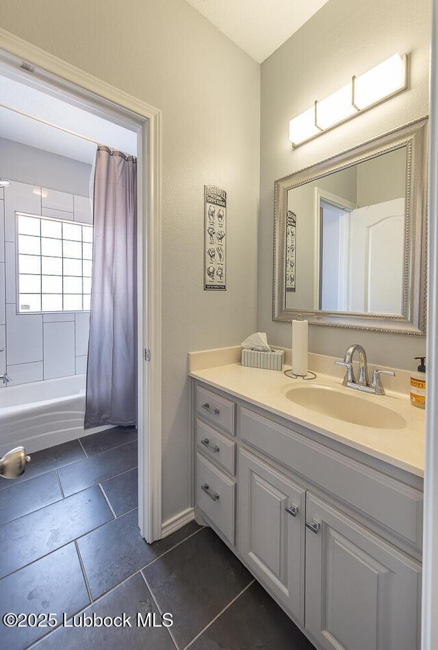 5004 County Rd 1430, Lubbock, TX 79407 - bathroom featuring vanity, shower / bath combo with shower curtain, and tile patterned flooring