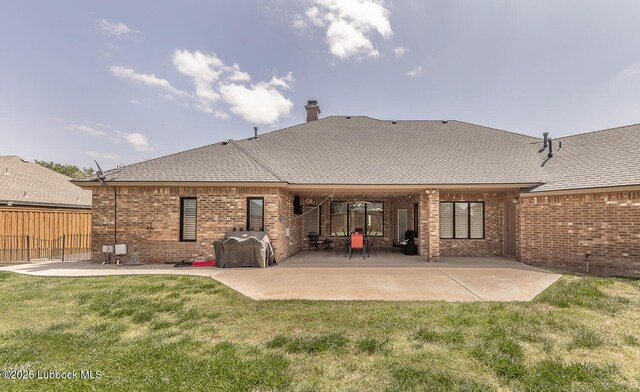 5004 County Rd 1430, Lubbock, TX 79407 - rear view of house with brick siding, a patio area, and a chimney