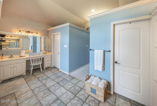 5004 County Rd 1430, Lubbock, TX 79407 - bathroom with vaulted ceiling, vanity, baseboards, and crown molding