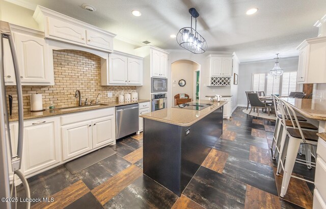 5004 County Rd 1430, Lubbock, TX 79407 - kitchen featuring stainless steel appliances, a sink, ornamental molding, recessed lighting, and white cabinets