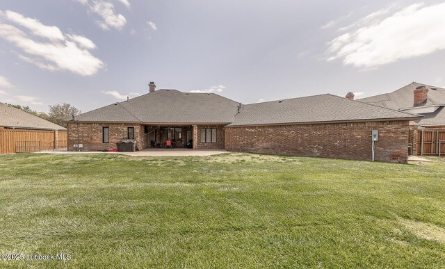 5004 County Rd 1430, Lubbock, TX 79407 - rear view of property with a patio area, brick siding, and a shingled roof