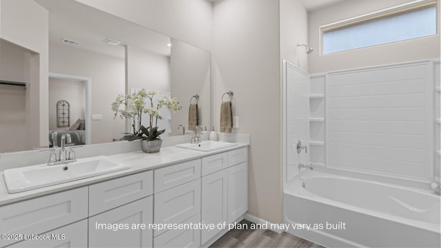 2337 149th St, Lubbock, TX 79423 - bathroom featuring double vanity, wood finished floors, and bathtub / shower combination