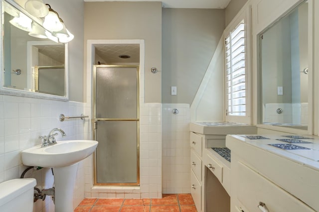 bathroom with a healthy amount of sunlight, toilet, a shower with shower door, and tile patterned flooring