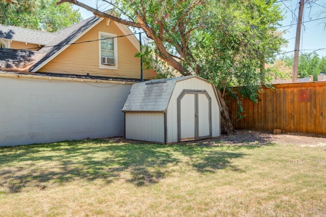 view of outbuilding featuring cooling unit and a lawn