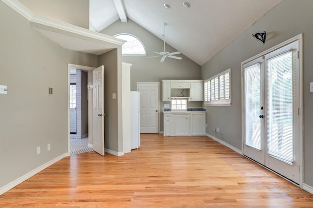 interior space featuring high vaulted ceiling, white cabinets, white fridge, beam ceiling, and light hardwood / wood-style flooring