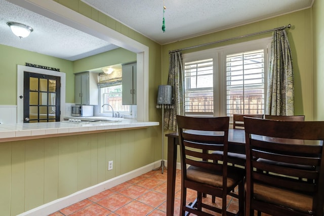 dining area with light tile patterned floors and a textured ceiling