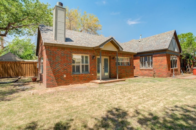 rear view of property featuring a yard