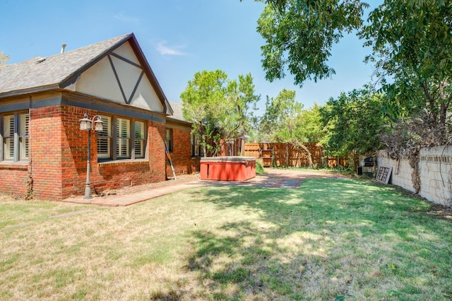 view of yard featuring a hot tub and a patio