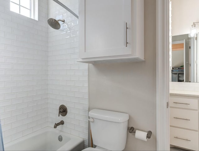 full bathroom featuring vanity, toilet, and tiled shower / bath