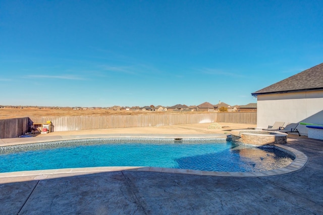 view of swimming pool featuring a patio and an in ground hot tub