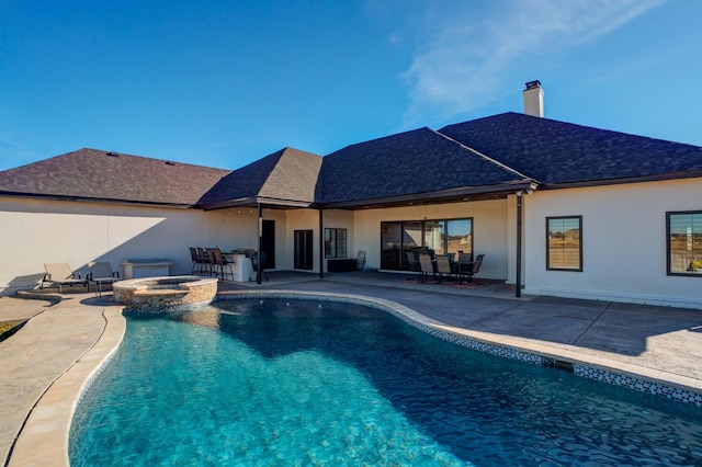 view of pool featuring an in ground hot tub and a patio area