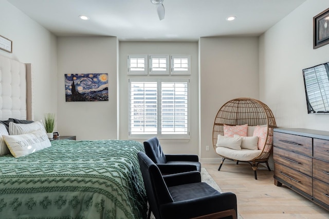 bedroom with ceiling fan and light wood-type flooring