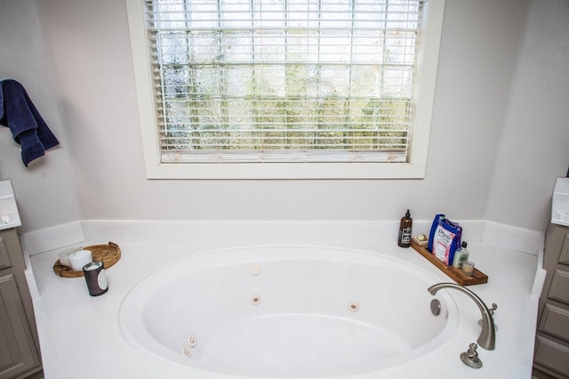 bathroom featuring a tub to relax in and vanity