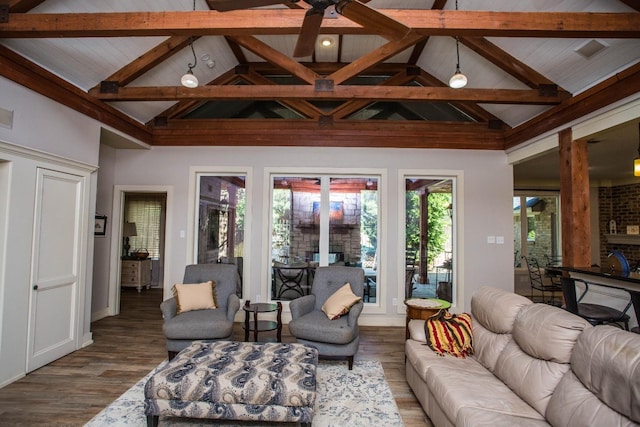 living room featuring hardwood / wood-style flooring, ceiling fan, and lofted ceiling with beams