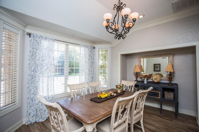 dining area featuring a notable chandelier, dark wood-type flooring, ornamental molding, and vaulted ceiling