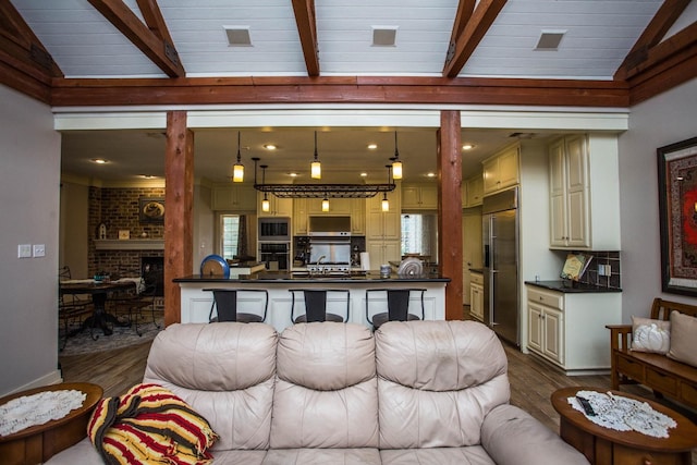 living room featuring a fireplace, dark hardwood / wood-style floors, and lofted ceiling with beams