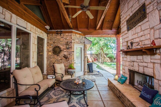 view of patio / terrace with ceiling fan and an outdoor stone fireplace