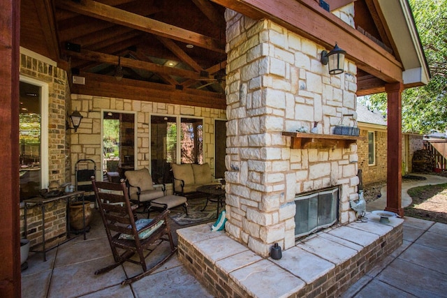 view of patio featuring an outdoor stone fireplace