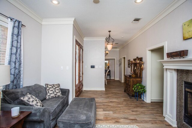 living room with hardwood / wood-style flooring and ornamental molding