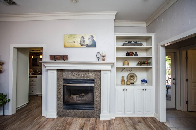 living room with hardwood / wood-style floors and crown molding