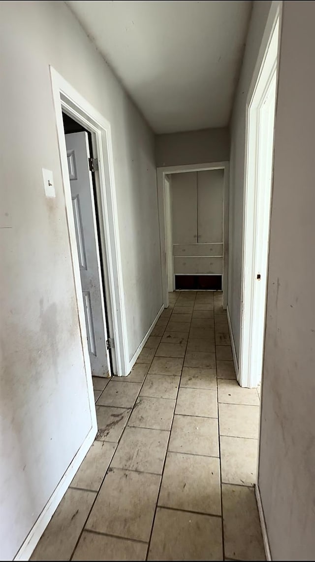 hall featuring light tile patterned flooring