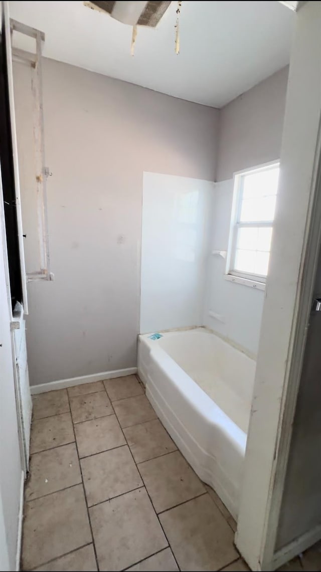 bathroom featuring a bath and tile patterned floors