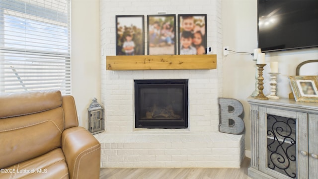 1105 Cajun St, Odessa, TX 79765 - living area with a brick fireplace and wood finished floors