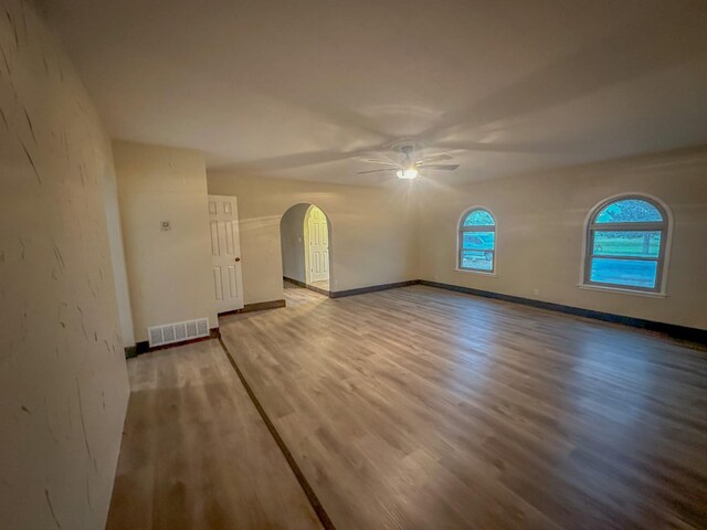 unfurnished room featuring hardwood / wood-style floors and ceiling fan