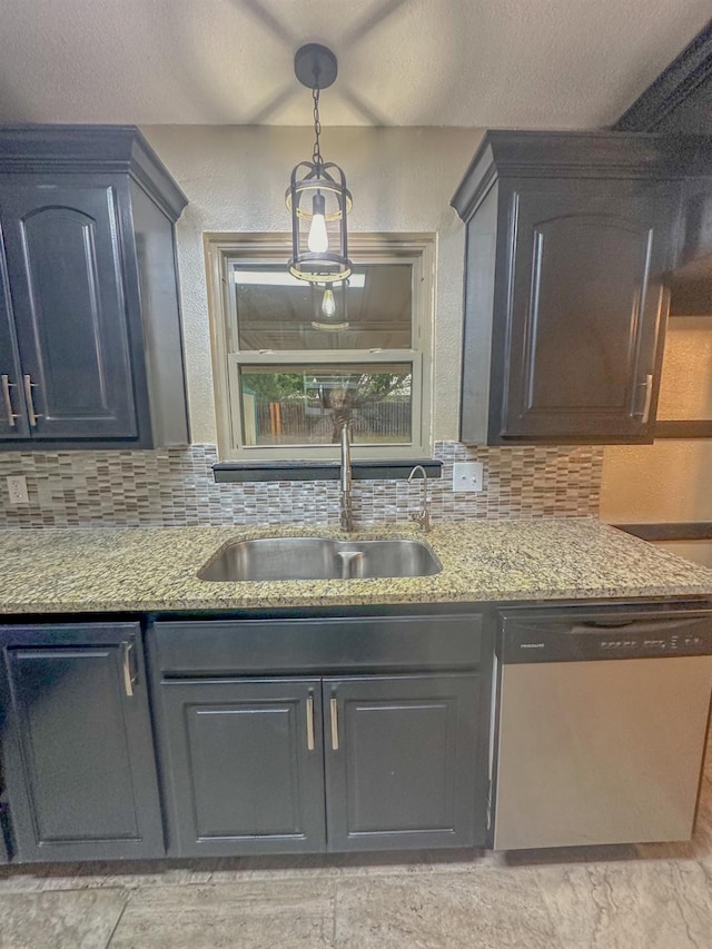 kitchen featuring tasteful backsplash, dishwasher, sink, light stone counters, and a textured ceiling