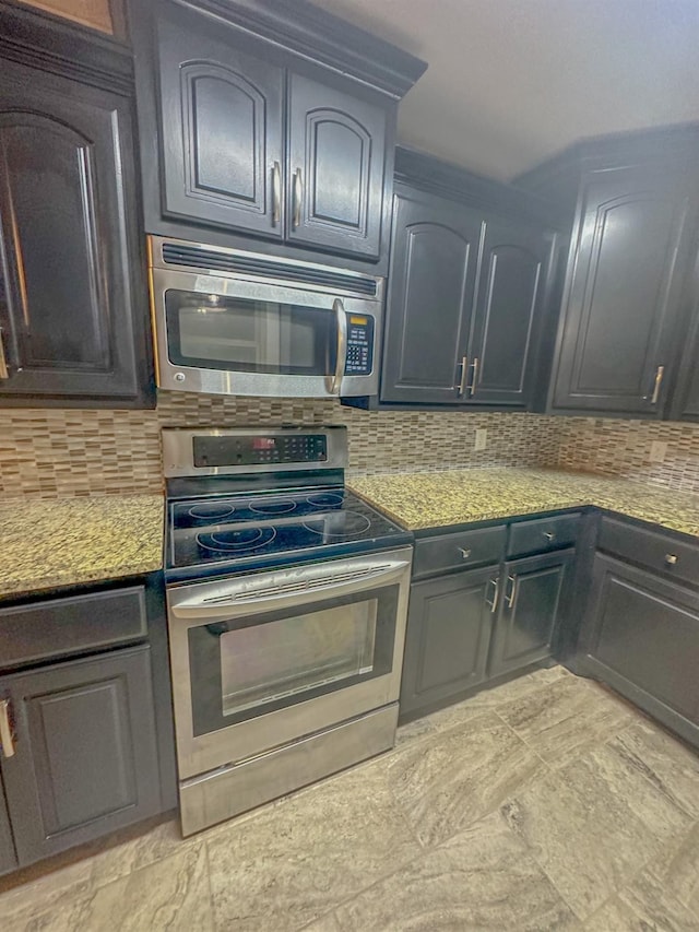 kitchen featuring light stone counters, backsplash, and appliances with stainless steel finishes