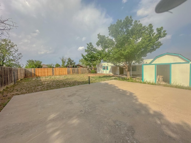 view of patio featuring a storage unit