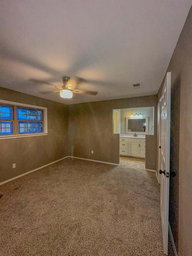 unfurnished bedroom with ceiling fan and light colored carpet