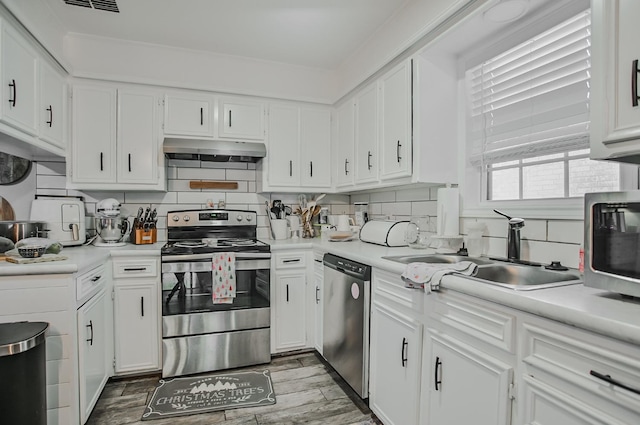 kitchen with white cabinetry, sink, tasteful backsplash, and appliances with stainless steel finishes