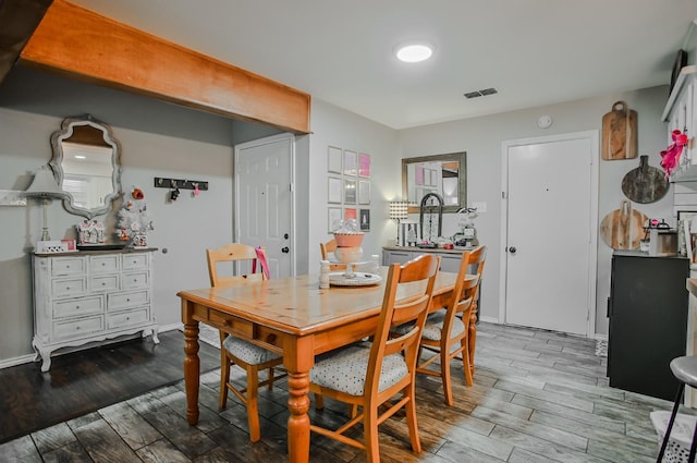 dining area with hardwood / wood-style floors