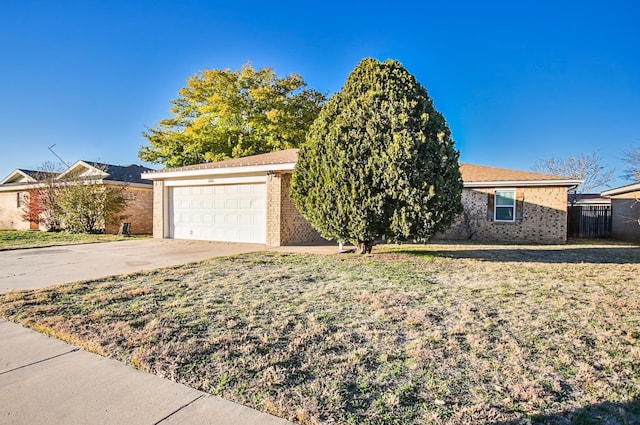 ranch-style house with a garage and a front lawn