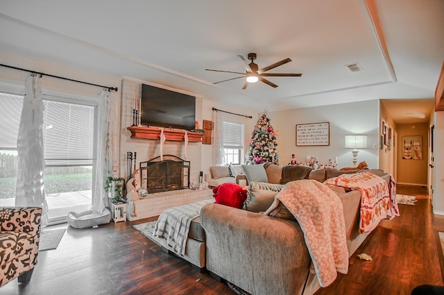 living room with a fireplace, dark hardwood / wood-style floors, and ceiling fan