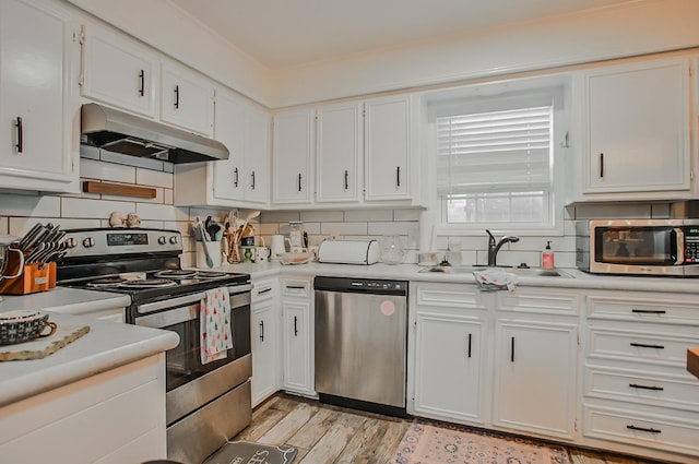 kitchen featuring white cabinetry, sink, decorative backsplash, and appliances with stainless steel finishes