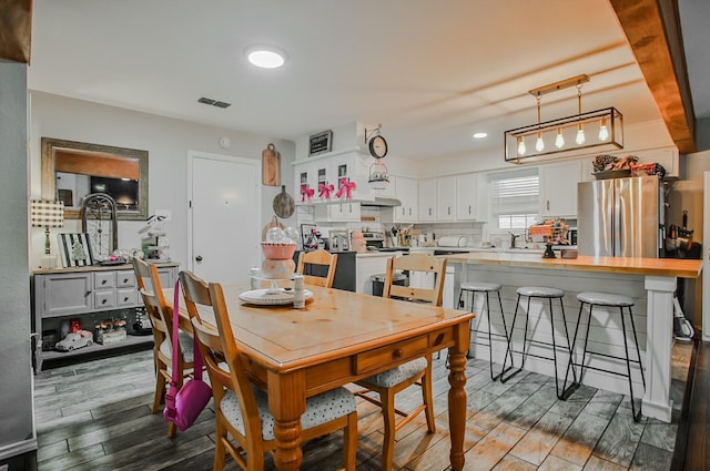 dining room featuring hardwood / wood-style flooring and sink