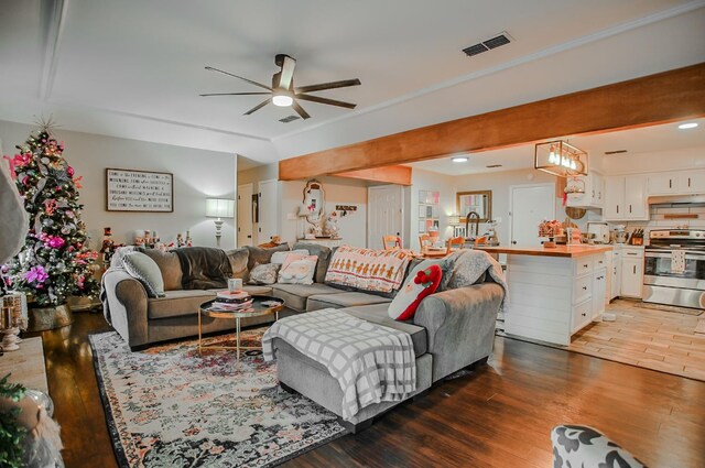 living room featuring dark hardwood / wood-style floors and ceiling fan