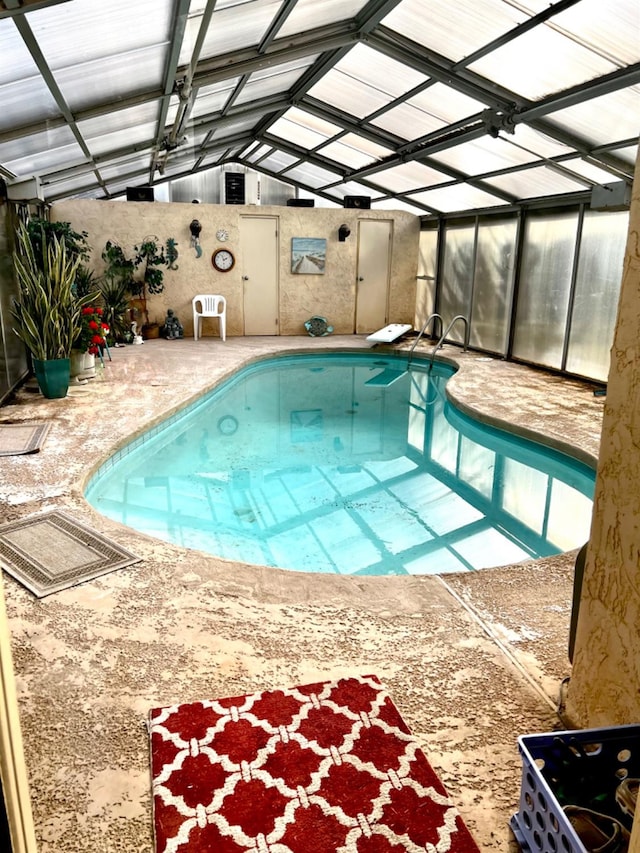 view of pool with a patio, a lanai, and a diving board