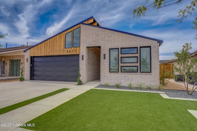 3617 127th St, Lubbock, TX 79423 - contemporary home with driveway, an attached garage, and brick siding