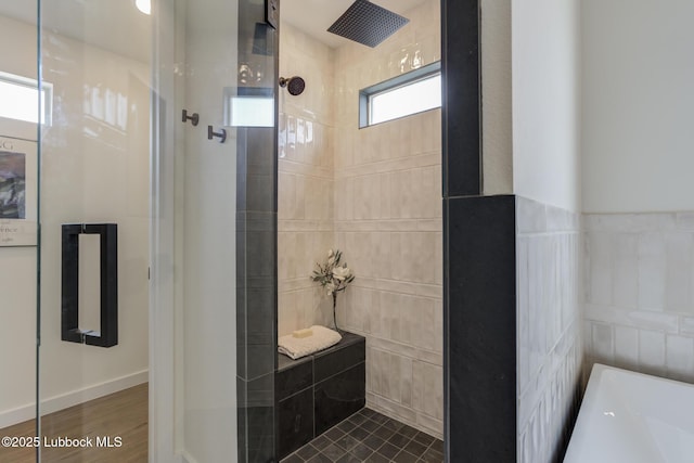 3617 127th St, Lubbock, TX 79423 - bathroom featuring tiled shower, a bathtub, and tile walls