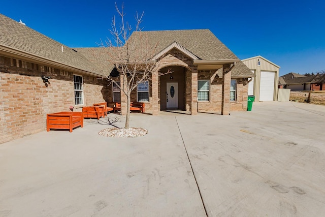 view of front of home featuring a garage, an outdoor hangout area, and a patio