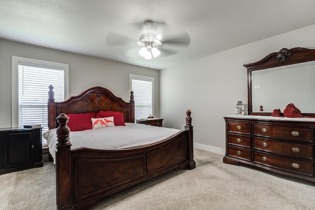 bedroom featuring light carpet and ceiling fan